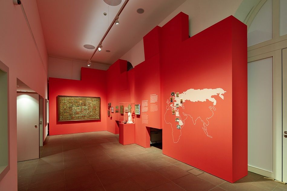Foyer des Ikonenmuseums mit Ikonen und eine Weltkarte auf roten Wandeinbauten
